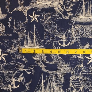 May include: A navy blue fabric with a white nautical map pattern. The map features ships, anchors, stars, and text including "OCEANUS", "MAR DEL ZUR", "ASIAE NOVA", "EQUATOR", and "QUEST".