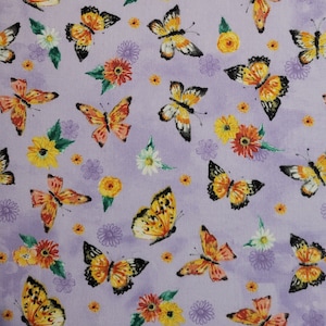 May include: A fabric with a repeating pattern of orange and black butterflies, yellow and orange flowers, and small white flowers on a light purple background. The butterflies have detailed wing patterns, and the flowers are clustered together.