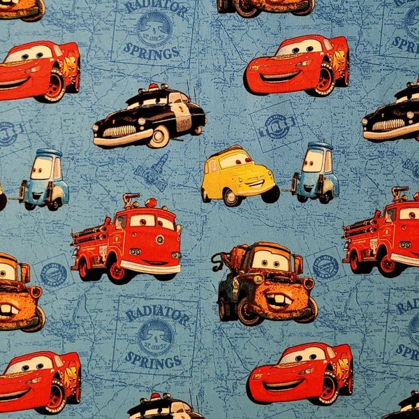 Cars fabric by Pixar and Disney. CP9786 Fabric by the yard and half yard. Lighting McQueen, Mater tow truck, Red fire truck, Disney fabric.