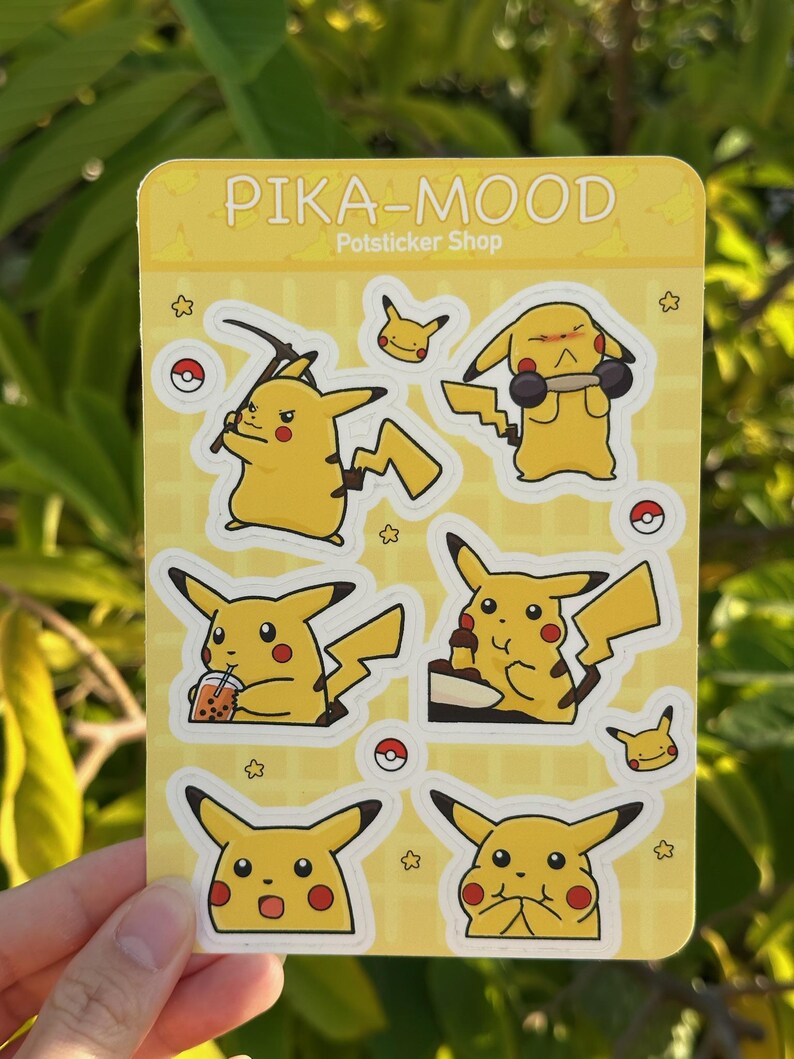 May include: A sheet of stickers featuring different expressions of Pikachu, a popular Pokemon character. The stickers are on a yellow background with a grid pattern and the text "PIKA-MOOD Potsticker Shop".