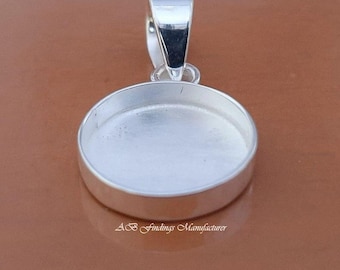 May include: A silver-colored pendant setting with a round bezel and a loop for a chain. The setting is designed to hold a round stone or cabochon. The text "AB Findings Manufacturer" is at the bottom.