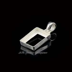 May include: Silver pendant with a rectangular bezel for a stone or cabochon. The pendant has a bail for attaching a chain.