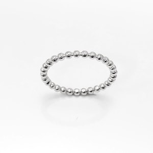 May include: A silver beaded ring with a simple design.