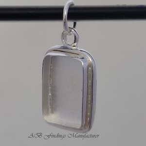 May include: Silver pendant with a rectangular bezel for a stone or cameo. The pendant has a bail for attaching to a chain.