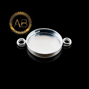 May include: A silver-colored round jewelry finding with two loops. The finding has a recessed area for setting a stone or other embellishment. The logo "AB FINDINGS GET A PERFECT MATCH" is in the upper left corner.