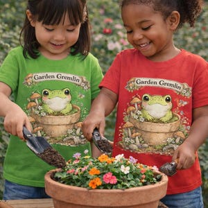 Garden Gremlin frog in flower pot Toddler T-shirt | whimsical mushroom garden design