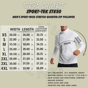 Op de afbeelding: Witte Sport-Tek ST850 quarter-zip pullover met een maattabel. De tabel toont afmetingen voor breedte, lengte en mouwlengte vanaf het midden van de rug, variërend van XS tot 4XL. Kenmerken zijn raglanmouwen, open manchetten en een gedrukt maat- en wasvoorschriftenlabel.