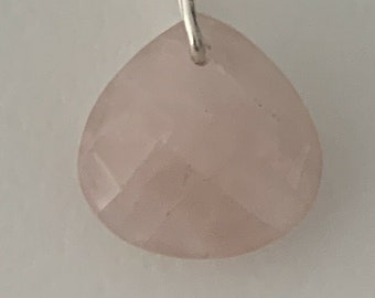 May include: A pale pink faceted gemstone pendant with a silver bail.