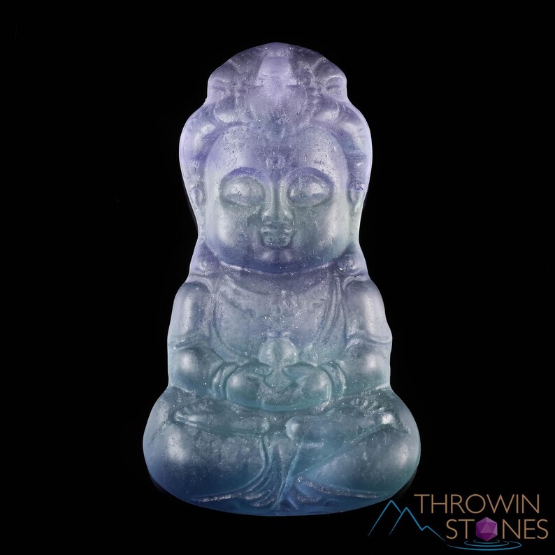 These rainbow Fluorite crystal pendants are carved in the shape of seated Buddha, with a small hole drilled.  Rainbow Fluorite is striated in sheer green, teal, and purple.
Crystals are nature-made therefore each one is unique in appearance.