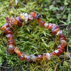 Carnelian chip bracelet. These tumbled chips range in color from orange to red, are drilled and strung on an elastic cord, and create an endless bracelet.