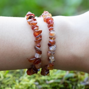 Carnelian chip bracelet. These tumbled chips range in color from orange to red, are drilled and strung on an elastic cord, and create an endless bracelet.
