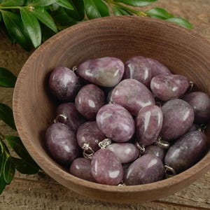 These purple Lepidolite crystal pendants are polished and freeform in shape.
Crystals are nature-made therefore each one is unique in appearance.