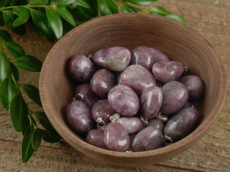 These purple Lepidolite crystal pendants are polished and freeform in shape.
Crystals are nature-made therefore each one is unique in appearance.