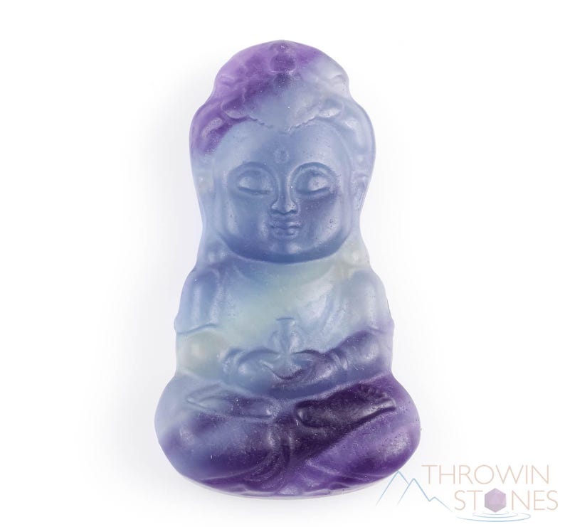 These rainbow Fluorite crystal pendants are carved in the shape of seated Buddha, with a small hole drilled.  Rainbow Fluorite is striated in sheer green, teal, and purple.
Crystals are nature-made therefore each one is unique in appearance.