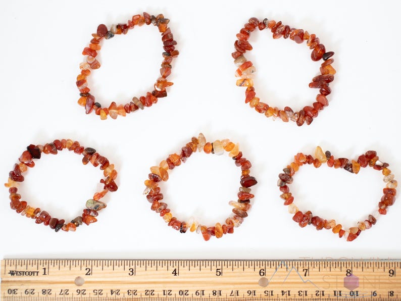Carnelian chip bracelet. These tumbled chips range in color from orange to red, are drilled and strung on an elastic cord, and create an endless bracelet.