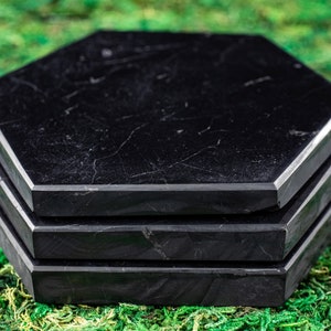 These are black Shungite crystal carved polished flat plate hexagons.
Crystals are nature-made therefore each one is unique in appearance.