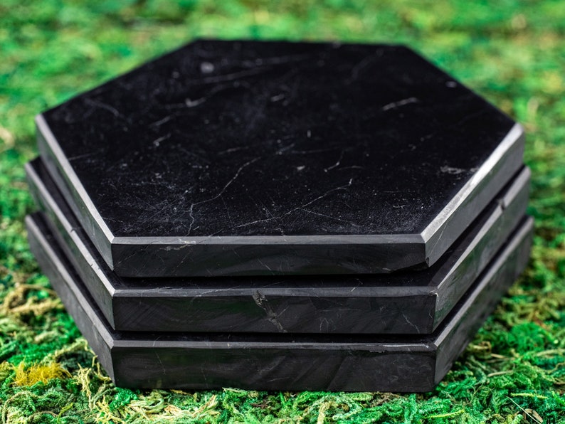 These are black Shungite crystal carved polished flat plate hexagons.
Crystals are nature-made therefore each one is unique in appearance.