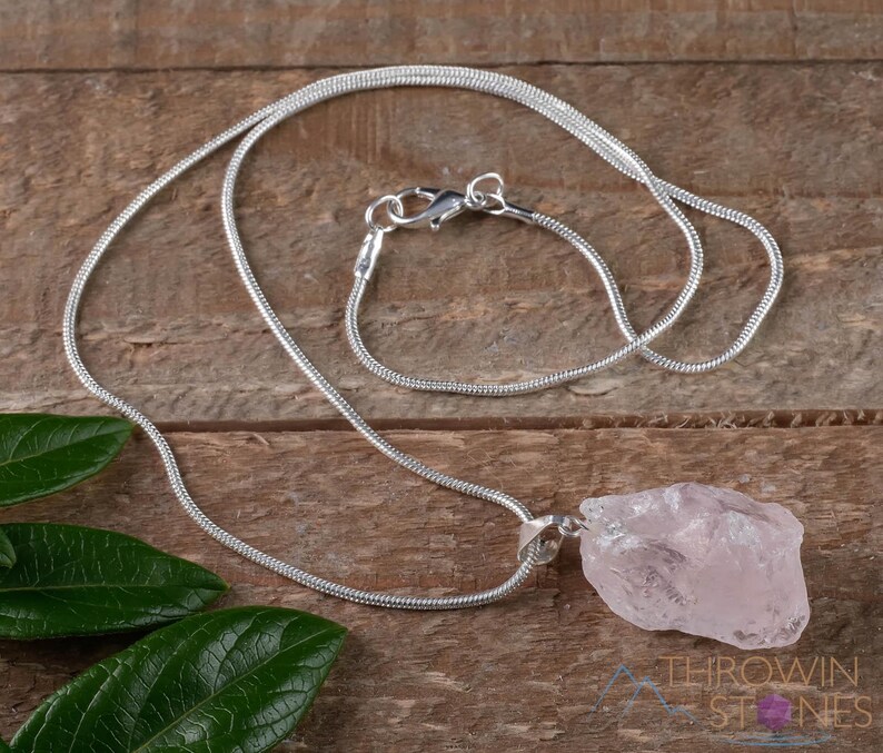 These pale pink Rose Quartz crystal jewelry sets are raw crystal chunk pendants strung on a silver chain, with matching earrings on silver ear hooks.  
Crystals are nature-made therefore each one is unique in appearance.