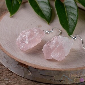 These pale pink Rose Quartz crystal jewelry sets are raw crystal chunk pendants strung on a silver chain, with matching earrings on silver ear hooks.  
Crystals are nature-made therefore each one is unique in appearance.
