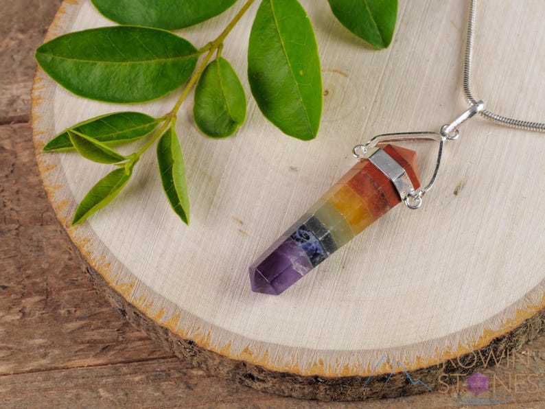 These rainbow chakra crystal pendants are polished double terminated points held in a silver bail.  The points are a composite of different crystals.
Crystals are nature-made therefore each one is unique in appearance.