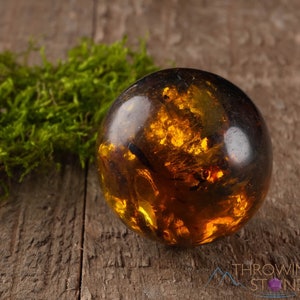 Genuine Amber Crystal Spheres. These semi precious orange crystal balls are between 15 and 40 millimeters in diameter and weigh between 1 and 40 grams. This listing has variations and only medium large and extra large spheres will come with a stand.