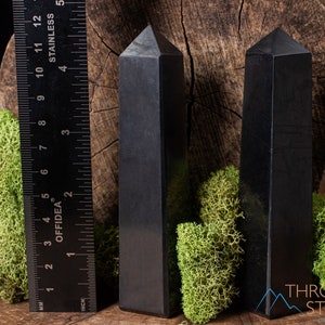 Shungite Crystal Tower. These genuine obelisk shaped crystal carvings are black with a polished finish and are great for crystal grids and decor. Each faceted crystal point is unique and will vary in size, shape, and color. Listing has variations.