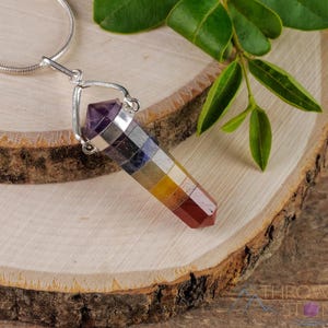 These rainbow chakra crystal pendants are polished double terminated points held in a silver bail.  The points are a composite of different crystals.
Crystals are nature-made therefore each one is unique in appearance.