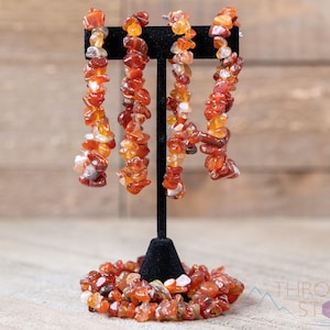Carnelian chip bracelet. These tumbled chips range in color from orange to red, are drilled and strung on an elastic cord, and create an endless bracelet.