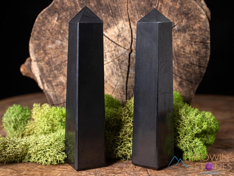 Shungite Crystal Tower. These genuine obelisk shaped crystal carvings are black with a polished finish and are great for crystal grids and decor. Each faceted crystal point is unique and will vary in size, shape, and color. Listing has variations.