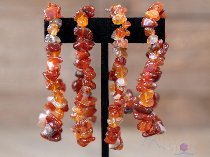 Carnelian chip bracelet. These tumbled chips range in color from orange to red, are drilled and strung on an elastic cord, and create an endless bracelet.