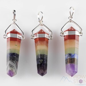 These rainbow chakra crystal pendants are polished double terminated points held in a silver bail.  The points are a composite of different crystals.
Crystals are nature-made therefore each one is unique in appearance.