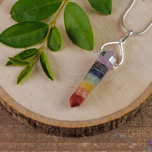 These rainbow chakra crystal pendants are polished double terminated points held in a silver bail.  The points are a composite of different crystals.
Crystals are nature-made therefore each one is unique in appearance.