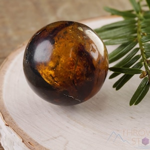 Genuine Amber Crystal Spheres. These semi precious orange crystal balls are between 15 and 40 millimeters in diameter and weigh between 1 and 40 grams. This listing has variations and only medium large and extra large spheres will come with a stand.