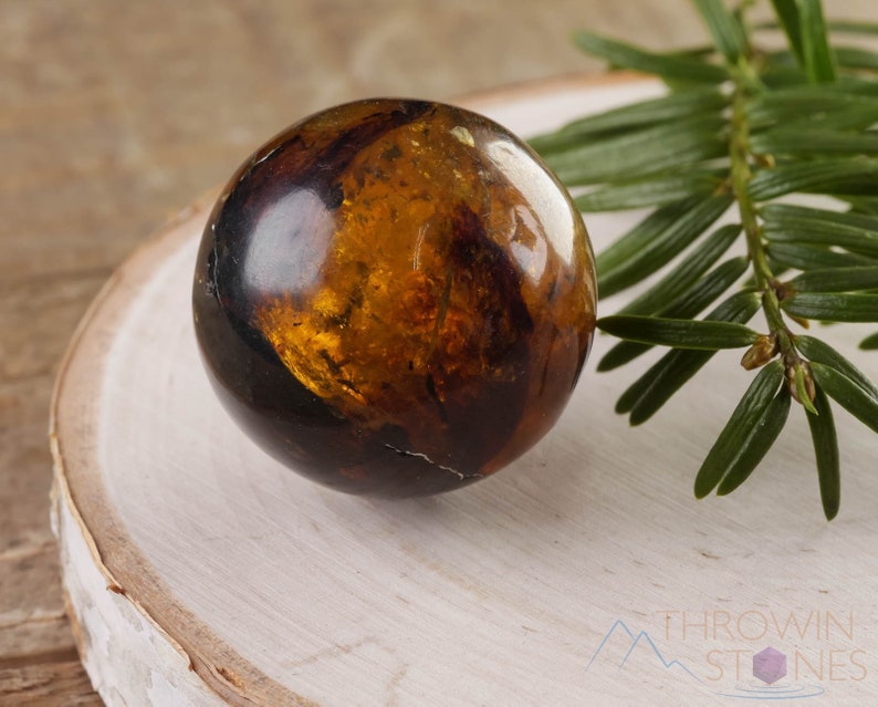 Genuine Amber Crystal Spheres. These semi precious orange crystal balls are between 15 and 40 millimeters in diameter and weigh between 1 and 40 grams. This listing has variations and only medium large and extra large spheres will come with a stand.