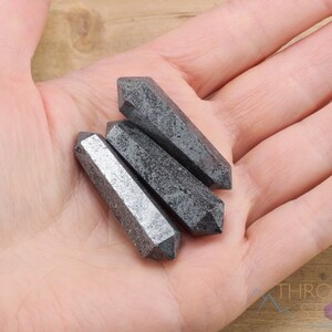 Hematite Mini Crystal Points. These metallic grey miniature wands are double terminated with a polished finish. Each gemstone is unique and will vary in size, shape, and color. These miniature points are great for jewelry making and crystal decor.