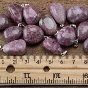 These purple Lepidolite crystal pendants are polished and freeform in shape.
Crystals are nature-made therefore each one is unique in appearance.