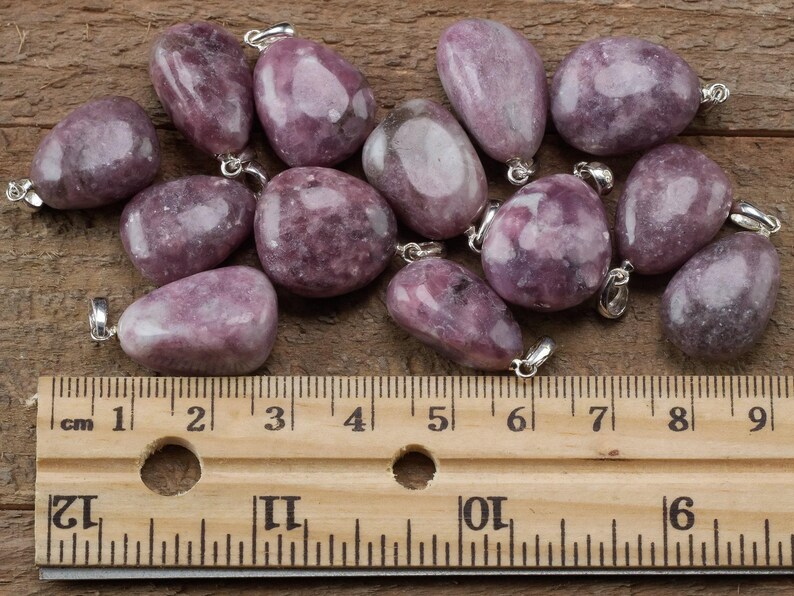 These purple Lepidolite crystal pendants are polished and freeform in shape.
Crystals are nature-made therefore each one is unique in appearance.