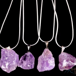 These pale lilac colored Amethyst crystal jewelry sets are raw crystal chunk pendants strung on a silver chain, with matching earrings on silver ear hooks.  
Crystals are nature-made therefore each one is unique in appearance.
