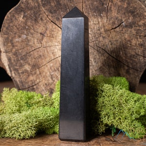 Shungite Crystal Tower. These genuine obelisk shaped crystal carvings are black with a polished finish and are great for crystal grids and decor. Each faceted crystal point is unique and will vary in size, shape, and color. Listing has variations.