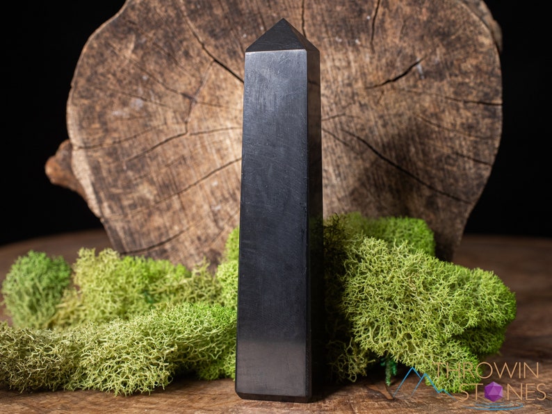 Shungite Crystal Tower. These genuine obelisk shaped crystal carvings are black with a polished finish and are great for crystal grids and decor. Each faceted crystal point is unique and will vary in size, shape, and color. Listing has variations.