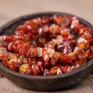 Carnelian chip bracelet. These tumbled chips range in color from orange to red, are drilled and strung on an elastic cord, and create an endless bracelet.