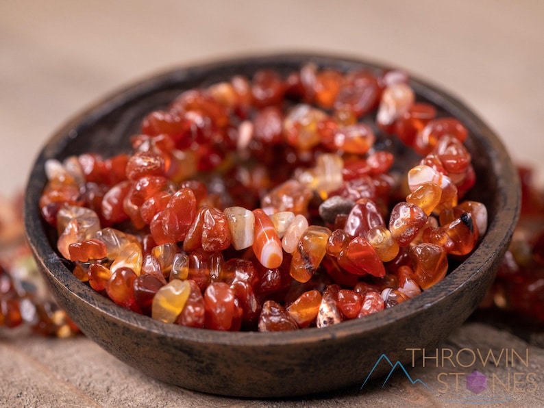 Carnelian chip bracelet. These tumbled chips range in color from orange to red, are drilled and strung on an elastic cord, and create an endless bracelet.