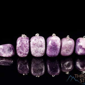 These purple Lepidolite crystal pendants are polished and freeform in shape.
Crystals are nature-made therefore each one is unique in appearance.