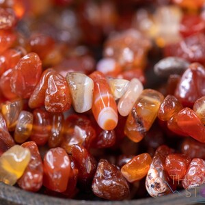 Carnelian chip bracelet. These tumbled chips range in color from orange to red, are drilled and strung on an elastic cord, and create an endless bracelet.