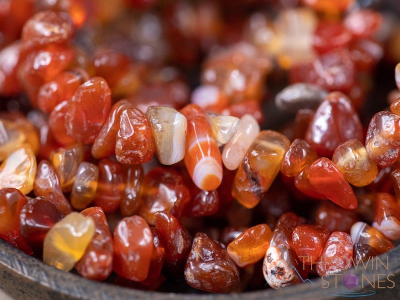 Carnelian chip bracelet. These tumbled chips range in color from orange to red, are drilled and strung on an elastic cord, and create an endless bracelet.