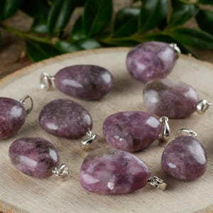 These purple Lepidolite crystal pendants are polished and freeform in shape.
Crystals are nature-made therefore each one is unique in appearance.