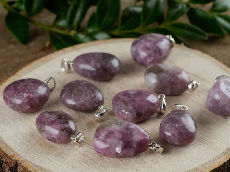 These purple Lepidolite crystal pendants are polished and freeform in shape.
Crystals are nature-made therefore each one is unique in appearance.