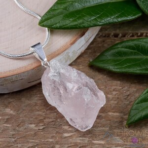 These pale pink Rose Quartz crystal jewelry sets are raw crystal chunk pendants strung on a silver chain, with matching earrings on silver ear hooks.  
Crystals are nature-made therefore each one is unique in appearance.