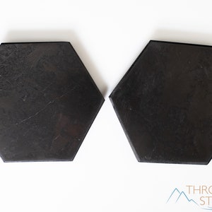 These are black Shungite crystal carved polished flat plate hexagons.
Crystals are nature-made therefore each one is unique in appearance.
