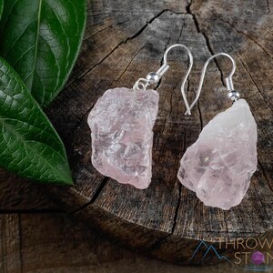 These pale pink Rose Quartz crystal jewelry sets are raw crystal chunk pendants strung on a silver chain, with matching earrings on silver ear hooks.  
Crystals are nature-made therefore each one is unique in appearance.